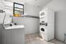 Dedicated laundry area featuring commercial-grade washers and dryers