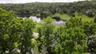 Aerial view of lot with a large pond across the road