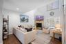 Homeowner's Cozy Living Space with Soaring Ceilings and lots of Natural Sunlight.  Wood Burning Fireplace for cool nights