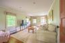 Living room featuring a baseboard radiator, crown molding, and wood-type flooring