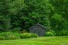 View of outbuilding with a wooded view