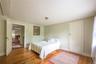 Bedroom with hardwood / wood-style flooring and baseboards