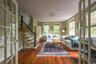 Living area with stairway, wood finished floors, baseboard heating, and a baseboard radiator