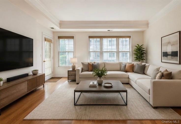 Hardwood flooring extends throughout this space, complemented by a large area rug