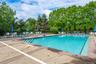Rectangular swimming pool with integrated steps, surrounded by a concrete deck