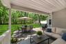 A deck and patio create inviting spaces for outdoor entertaining.