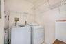 Dedicated laundry area featuring white walls and wire shelving