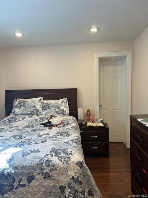 Hardwood-style flooring extends throughout this room, complemented by a white door and trim