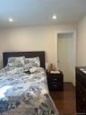 Hardwood-style flooring extends throughout this room, complemented by a white door and trim