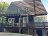 Sheltered area under deck leads to walk out basement  with 2 doors  .