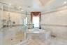 Full bathroom featuring a shower stall, tile walls, a garden tub, tile patterned flooring, and crown molding