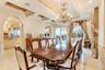 Dining space featuring arched walkways, french doors, ornamental molding, light tile patterned floors, and recessed lighting