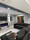 Living room with a large fireplace, crown molding, and hardwood / wood-style floors