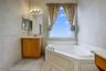 Spacious primary bath with two vanity areas & separate tub & shower