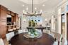 Dining space with a raised ceiling, ornamental molding, pool table, and recessed lighting