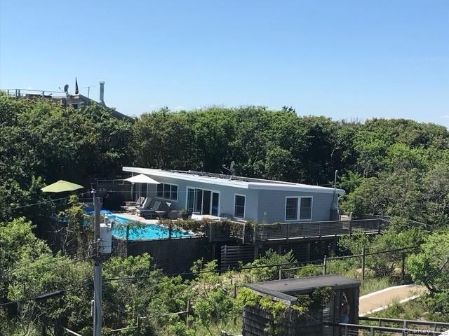 Back of property featuring a forest view