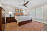 Well-sized guest bedroom with refined finishes and abundant natural light.
