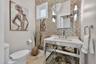 Elegant half bathroom with upscale fixtures and a sophisticated aesthetic.