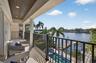Private primary balcony with captivating views of the pool, deep-water canal, and dock.
