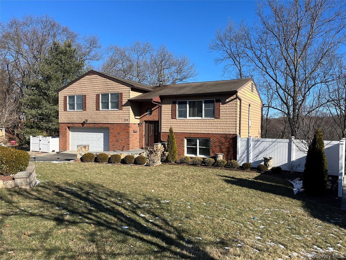 View of front of home featuring a garage and a front lawn