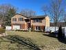 View of front of home featuring a garage and a front lawn