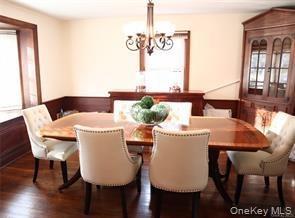 Large dining room with bay window overlooking front lawn