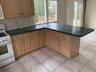 View on other side of counter of dining area and sliders out to deck