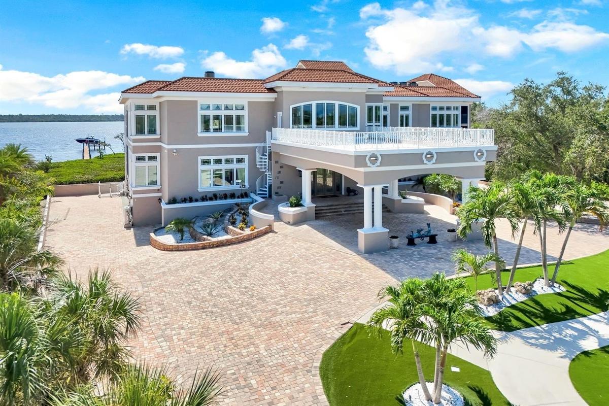 Elegant front entry with car port in circular driveway
