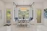 Bright dining area featuring a built-in window seat, large windows with garden railings, and two glass-paneled doors