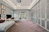 Bedroom featuring extensive built-in cabinetry, recessed lighting, and a modern chandelier