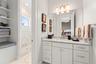 Private vanity area for bedroom 3 has marble vanity and floor, within the Jack-and-Jill bathroom