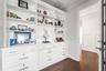Home office features custom built-in shelving and file cabinets for organized storage.