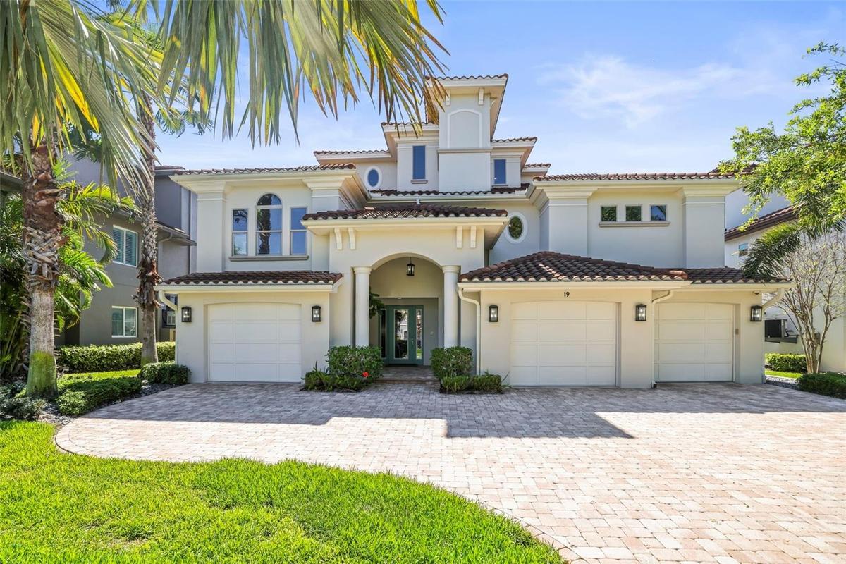 Gorgeous waterfront estate with a grand architectural presence, massive 5 car split garage & professionally designed landscaping