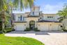Gorgeous waterfront estate with a grand architectural presence, massive 5 car split garage & professionally designed landscaping