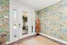Front entry foyer featuring automated security and lighting along with stylized wallpaper