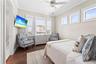 Bedroom 4 with water view windows/blinds, clerestory windows, mounted television, walk-in closet, private vanity, and access to a shared Jack-and-Jill