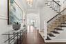 Landing from the ground level leading to the main living floor, which includes the primary suite, kitchen, dining area, office, laundry room, and a sp