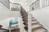 Elegant staircase leading to the upper level, connecting the home's living levels
