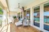 Second floor lanai with bahama shutters, custom planter & private access from the primary suite