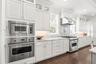 This kitchen is a chef's dream! Outfitted with premium gas-powered Viking appliances, including dual convection ovens, a professional six-burner cookt