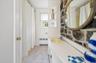 Full bath adjoining sunroom and storage closet.