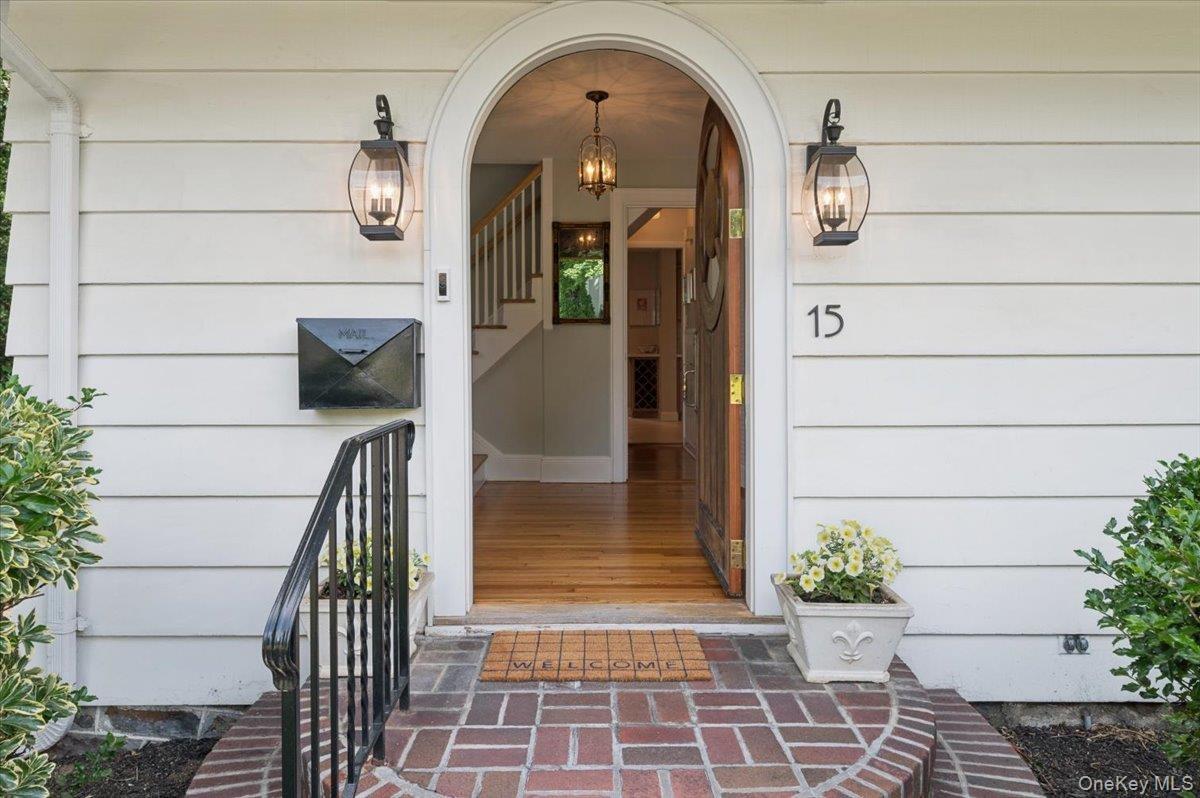 Love the arched door...this is a major Halloween trick or treating block so get ready to put pumpkins on this gorgeous entry!