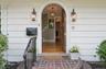 Love the arched door...this is a major Halloween trick or treating block so get ready to put pumpkins on this gorgeous entry!