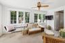 The office/sunroom has a wall of windows and a full bath to double as a guest space.