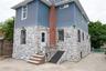 Rear of Home Exterior stone facade with complementary blue siding