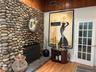 Feel the warmth from this rustic stone fireplace.