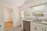 Kitchen with door out to patio for convenient summer grilling.