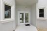 Ground floor entry under winding staircase