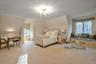 Carpeted bedroom featuring a notable chandelier and ornamental molding