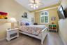 Main floor guest bedroom is spacious, light and bright with high ceilings